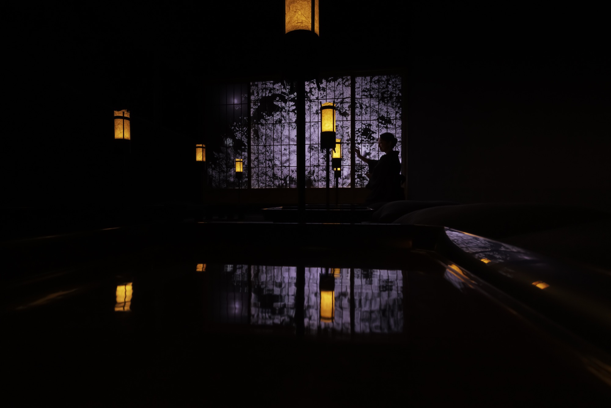 Sake sanctuary lit by lanterns at night